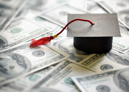 graduation cap sitting on money