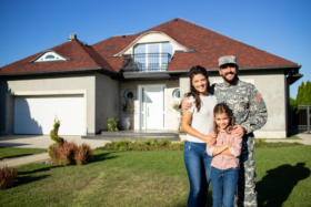 military family in front of their home