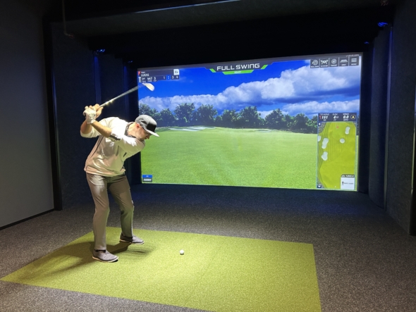 Man in golf simulator bay