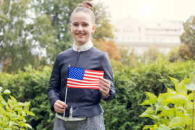 middle school girl holding American flag