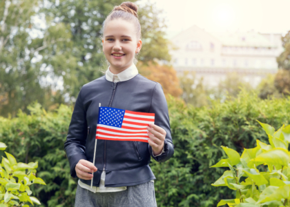 middle school girl holding American flag