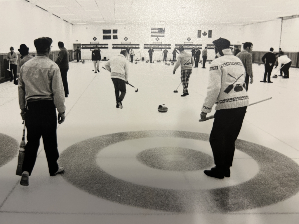 men curling circa 1963