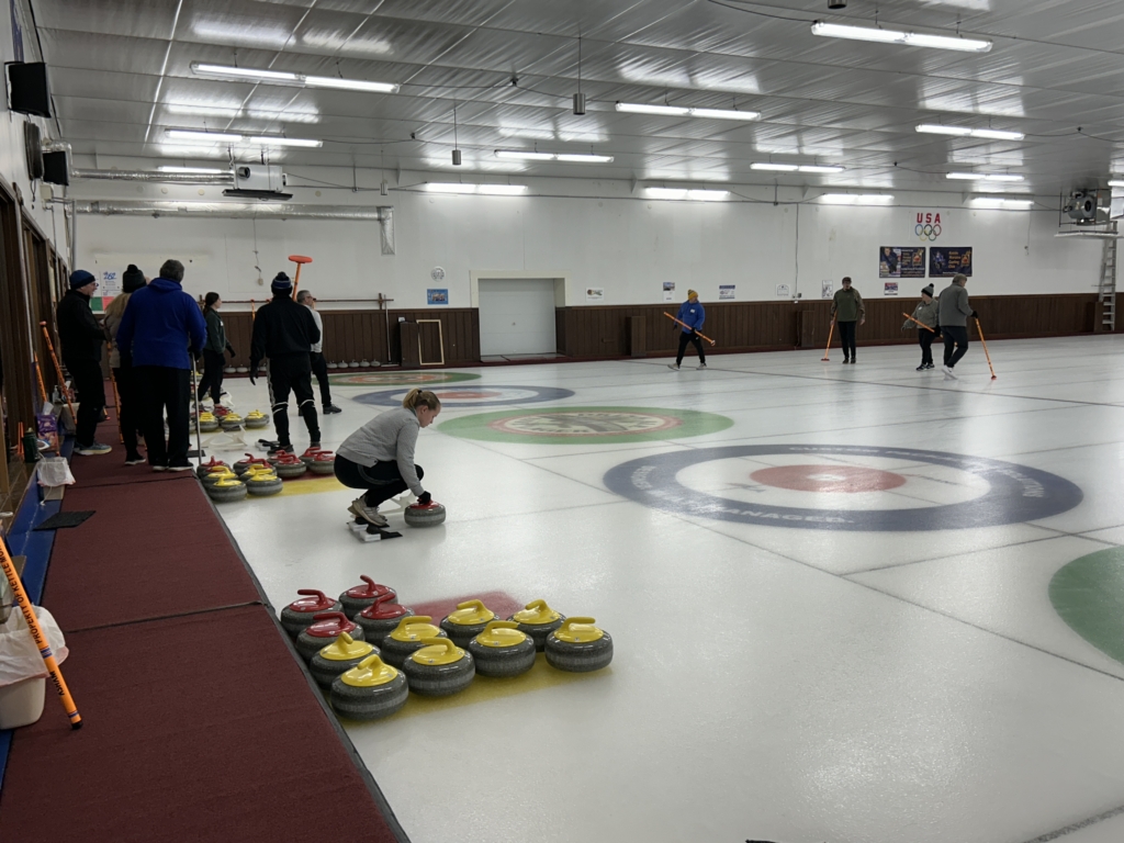 players participate in intro to curling class