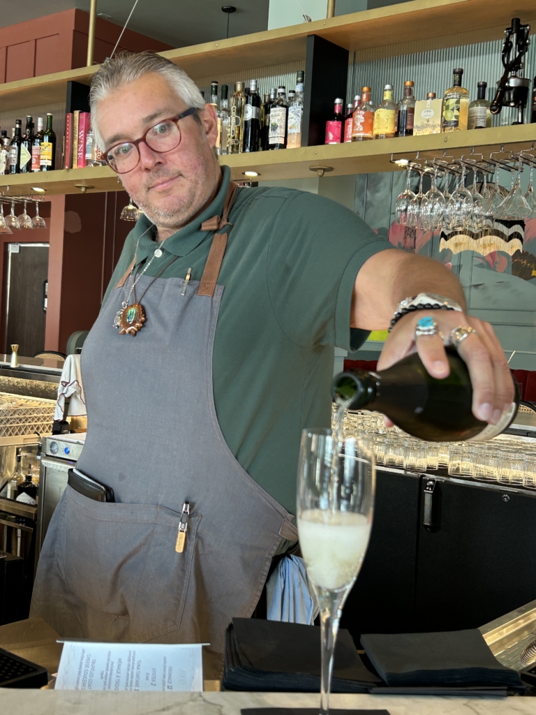 Bartender pours champagne